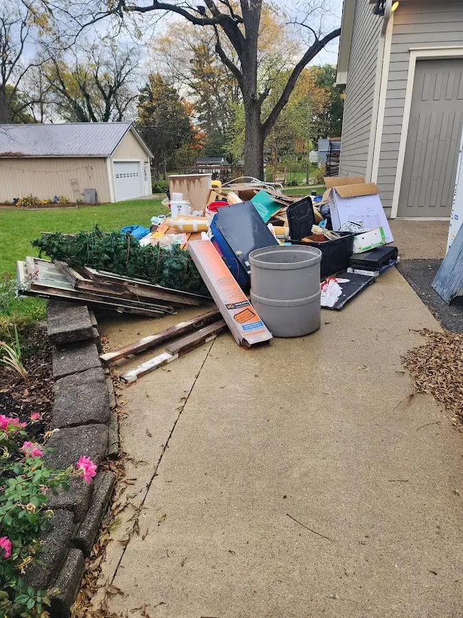 Dumpster being loaded with debris for Residential Dumpster Rental in Sioux Falls